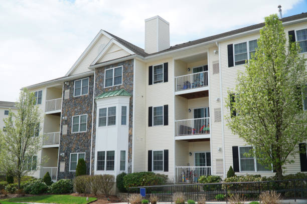 istock rental apartment buildings in a row with spring tree 2196669290
