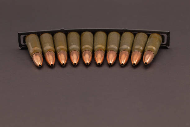 istock Stripper clip with rifle cartridges on dark background. 2196669509
