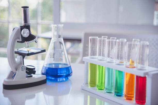 istock Science laboratory chemistry test science lab with microscope, glass tubes, chemical beaker white table scientific background. Colorful Liquid biology laboratory chemical fluid scientist experiment 2196670183