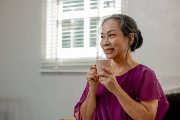 istock A kind-hearted elderly woman was contentedly spending her free time relaxing and doing various activities in her own home, Image of a happy and quality life of a retired old woman. 2196673210