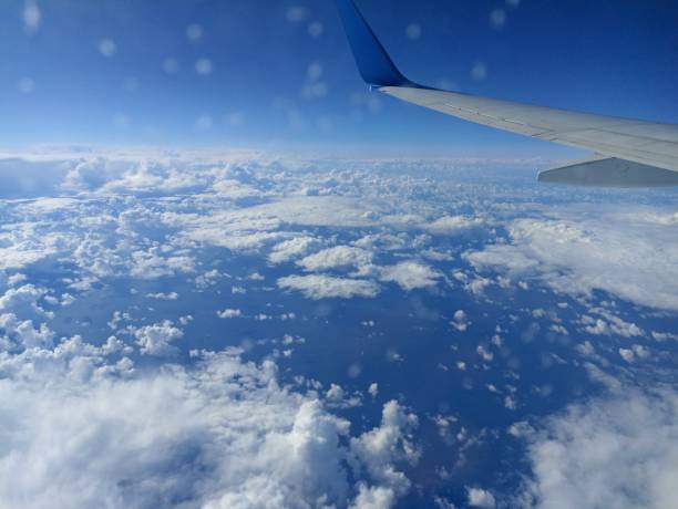 istock view from airplane window reflecting white clouds and glowing sea 2196673670