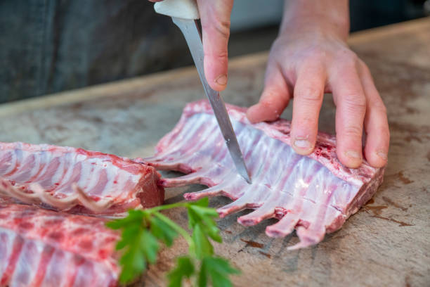 istock Butcher prepares rack of lamb 2196676906