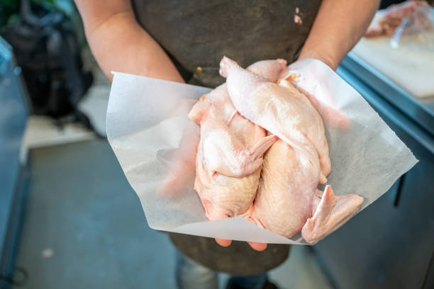 Butcher holds free-range chicken pieces