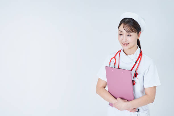 A female medical staff member holding a document and taking a medical examination