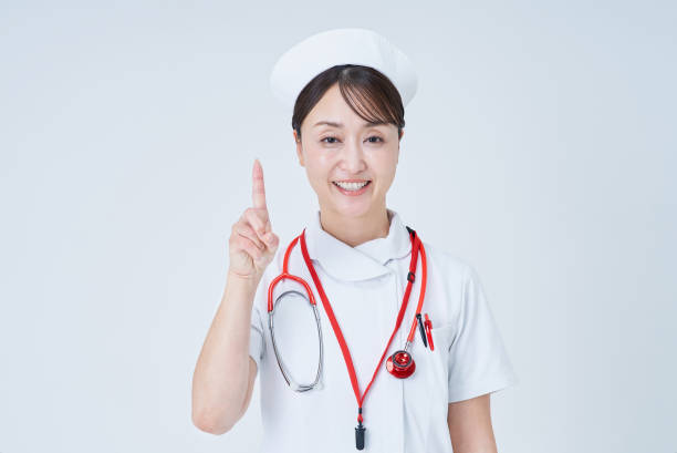 istock A woman in a white coat posing with her index finger up 2196682183