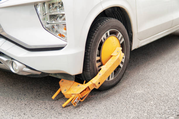 istock Yellow wheel clamp on an illegally parked car 2196683165