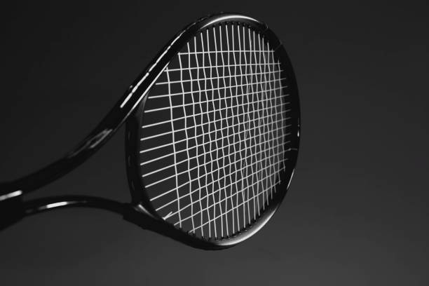 istock tennis balls and racket in a dark background 2196684133