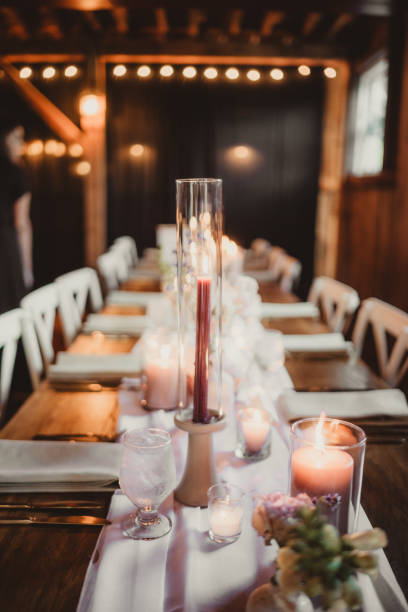 istock Long table at wedding reception with candles and place settings 2196688227