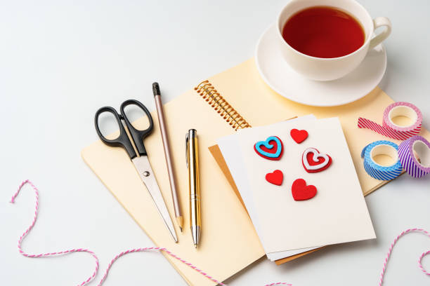 istock Crafting session with materials on a table alongside a warm cup of tea in a cozy space 2196688285