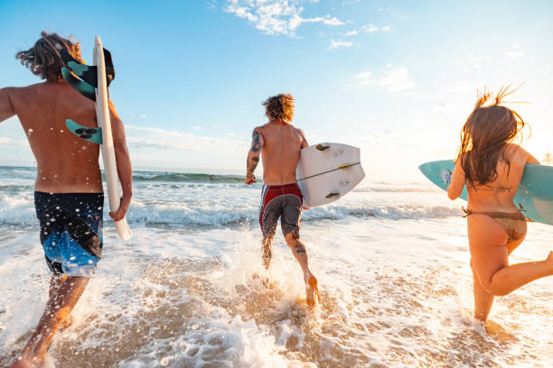 istock Surfers Running into Waves on Gold Coast Beach at Sunrise 2196688408
