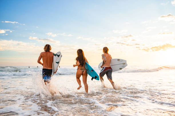 istock Young Surfers Enjoying Sunrise on Gold Coast Beach 2196688413