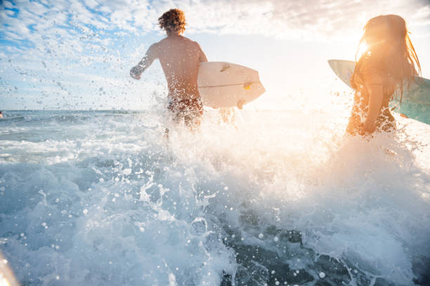 istock Surfers Running into Waves at Sunrise on Gold Coast 2196688422