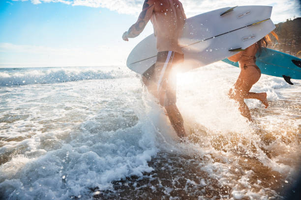 istock Surfers Running into Sunrise Waves at Gold Coast 2196688430