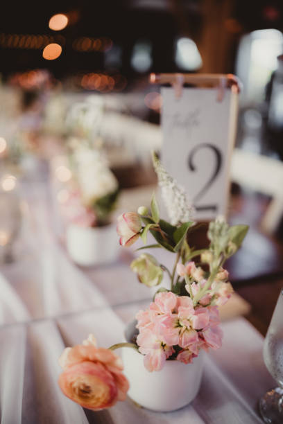 istock Table number with flower centerpieces and decorations at wedding reception 2196688469