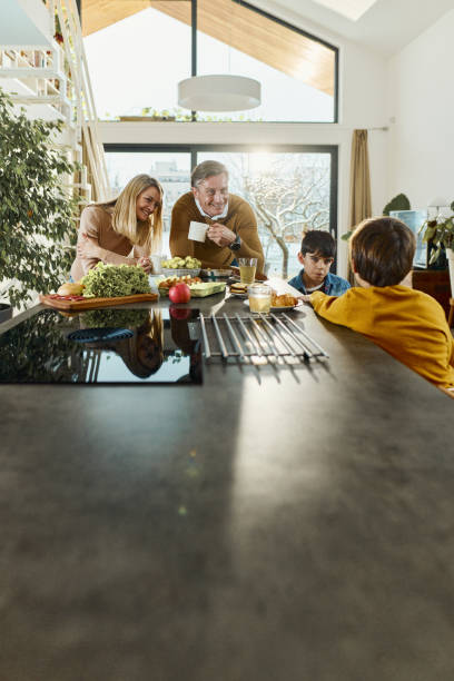 istock Happy family spending their time in the kitchen. 2196691326