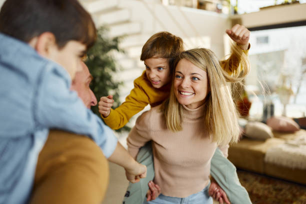 istock Happy family having fun while piggybacking at home. 2196691334