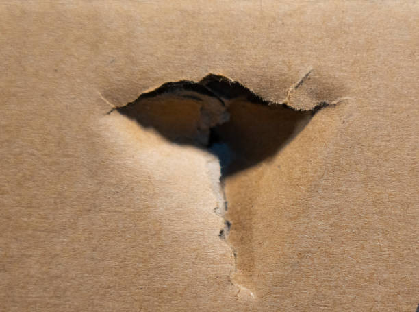 istock Torn hole in brown cardboard with rough edges 2196691417