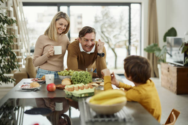 istock Happy parents talking to their son in the kitchen. 2196691537