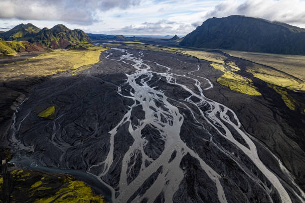 istock Aerial drone view exploring a river valley landscape with a amazing glacial basin very close to Thakgil (Pakgil) campsite near Vik in Iceland. M.ountains in the background 2196693030