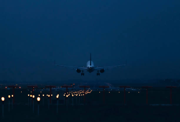 istock An airplane flies over the runway for landing 2196693235