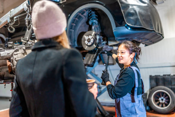istock Female mechanic explaining car repair to customer in workshop 2196695044