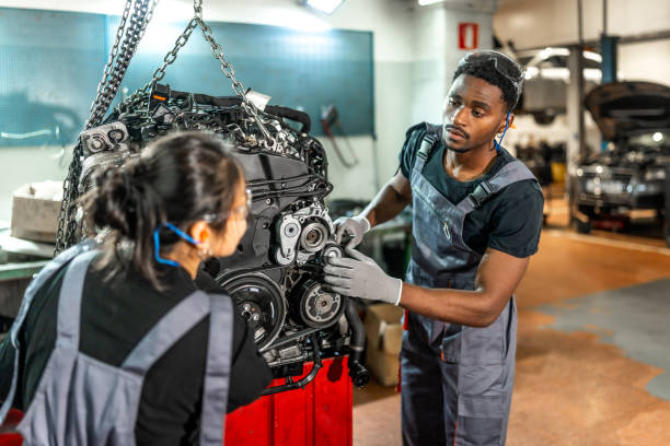 istock Mechanics working on car engine in auto repair shop 2196695283