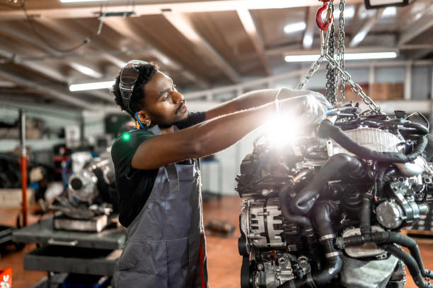 istock Professional mechanic repairing car engine in workshop 2196695304
