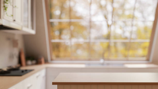 istock A minimal hardwood kitchen island, set in a contemporary kitchen featuring a large starlight window. 2196696381