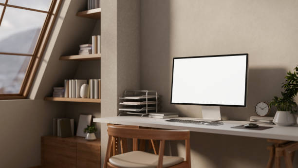 istock A contemporary Scandinavian apartment features a computer placed on a desk by the wall. 2196696624