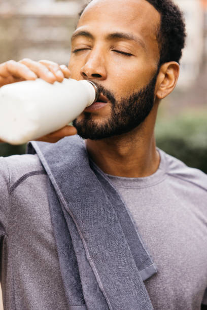 istock Man Hydrating After Exercise with Water Bottle Outdoors 2196698661