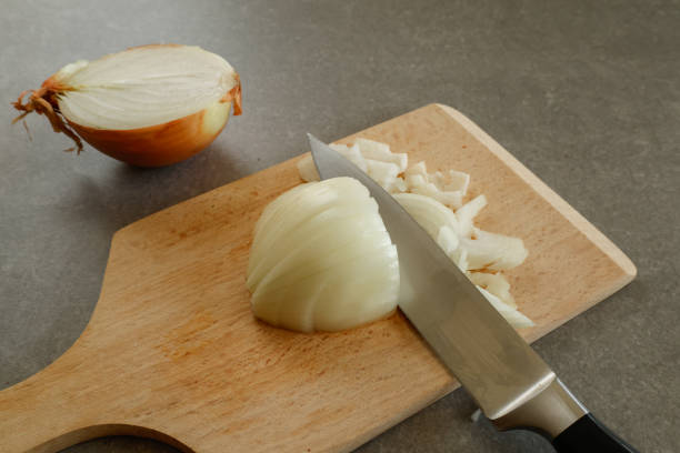 istock onion and knife on cutting board 2196698754