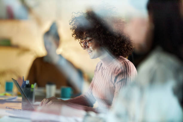 istock Happy female freelancer working on laptop in the office. 2196698929