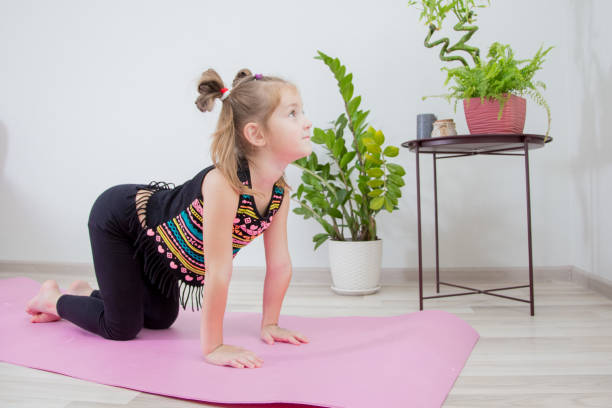 istock The little girl does yoga exercise. 2196701851