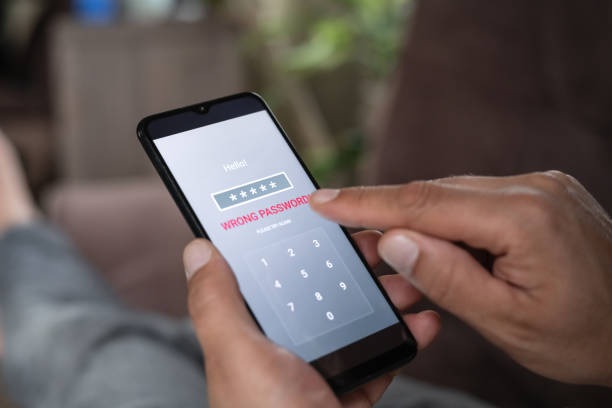 istock Man with smartphone trying to log in. Data security, data leaks and unauthorised access concepts. 2196703899
