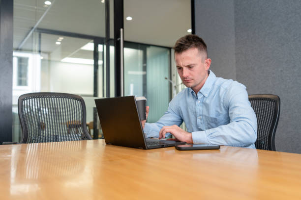 istock Focused Professional Working on Laptop in Modern Office 2196705314