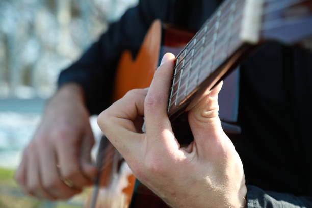 istock Man Plays Music With Classical Guitar Inexpensive Instrument 2196706437