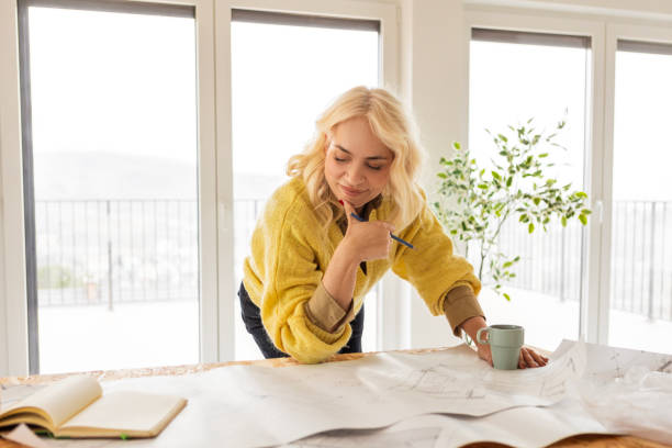 Woman Focused on Design Plans in a Stylish Office