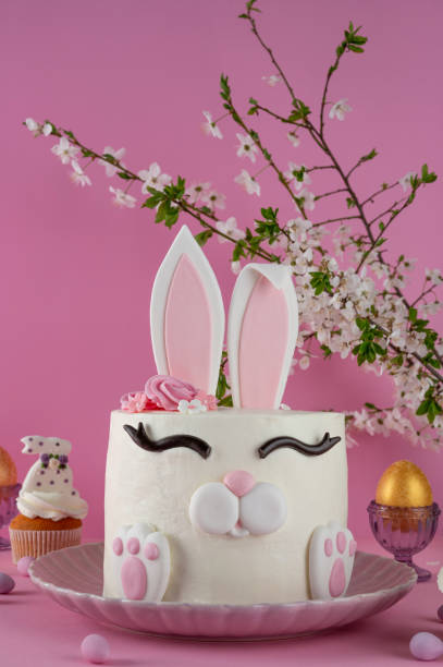 istock Easter bunny celebration cake on a plate on a pink background. Funny food idea. Copy space. 2196707056