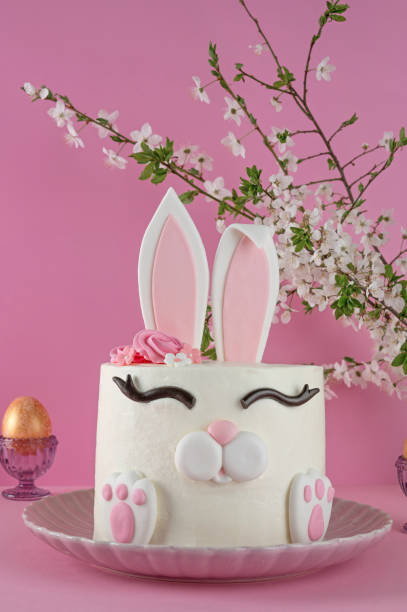 istock Easter bunny celebration cake on a plate on a pink background. Funny food idea. Copy space. 2196707087