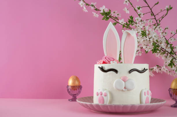 istock Easter bunny celebration cake on a plate on a pink background. Funny food idea. Copy space. 2196707093