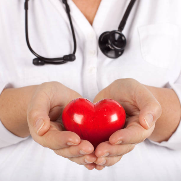 istock doctor with stethoscope holding a red heart in their hands 2196708106