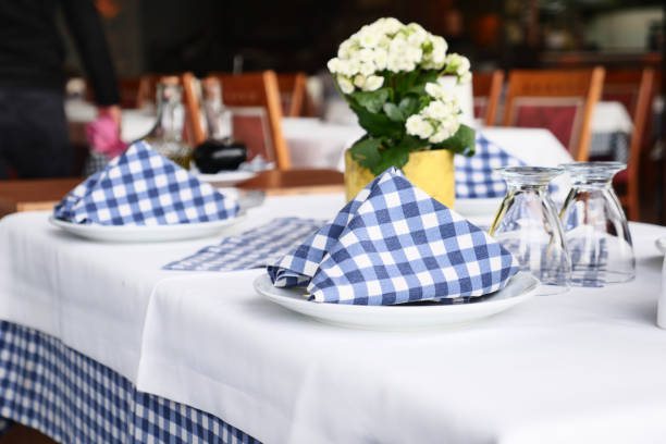 istock An elegantly charming restaurant table setting adorned with checkered napkins and beautiful flowers 2196709660