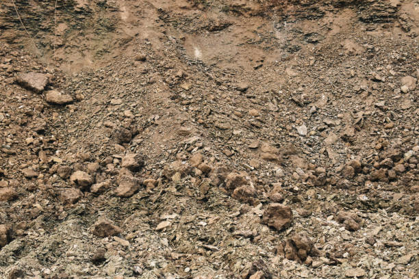 istock Uneven terrain filled with scattered rocks and soil at a construction site where excavation is taking place during daylight hours 2196710562