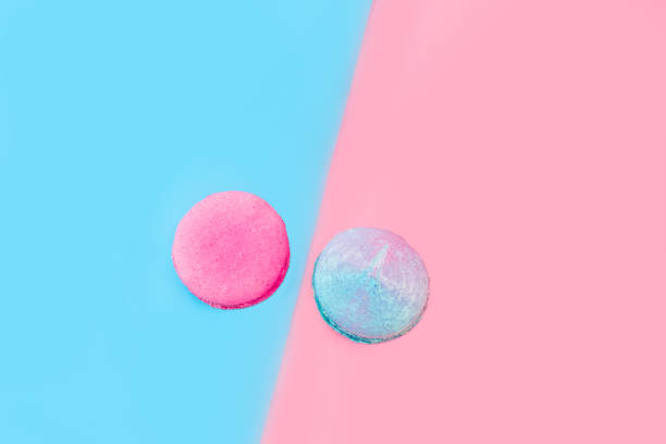 istock Traditional French multi-colored macaroons laid out on a pink and blue background. 2196711193