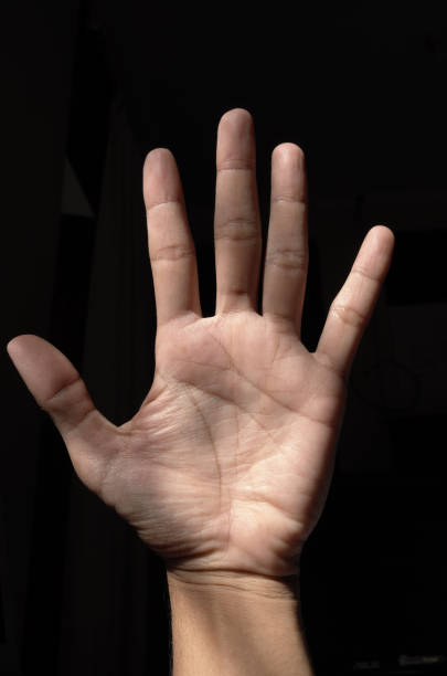 istock hand photo with black background 2196711353