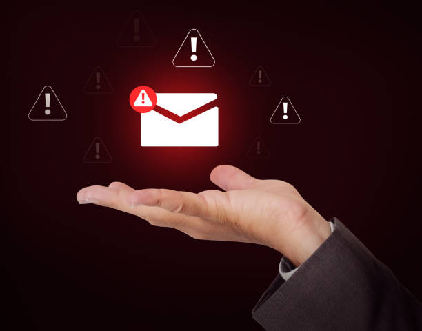 istock Spam Message hovering over the hand with red glowing light in the backdrop. Virus, electronic mail, error, spam email concept design 2196711873