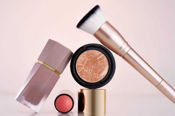 istock Makeup  brush, highlighter, blush and lipsticks on a nude background. Make up concept 2196716259