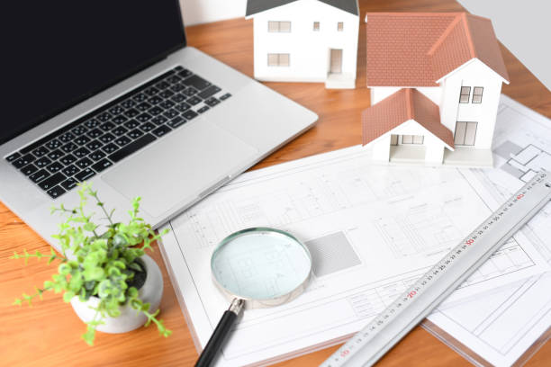 istock Architectural models, architectural drawings, and laptop computers lined up on the desk 2196717773