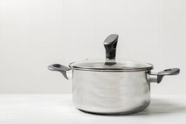 istock Stainless steel saucepan on light kitchen background. Modern saucepan. Kitchenware. Cooking pot. Cooking concept. Mockup. Space for text. Copy space. 2196718398