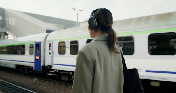 istock A woman at the train station 2196719809